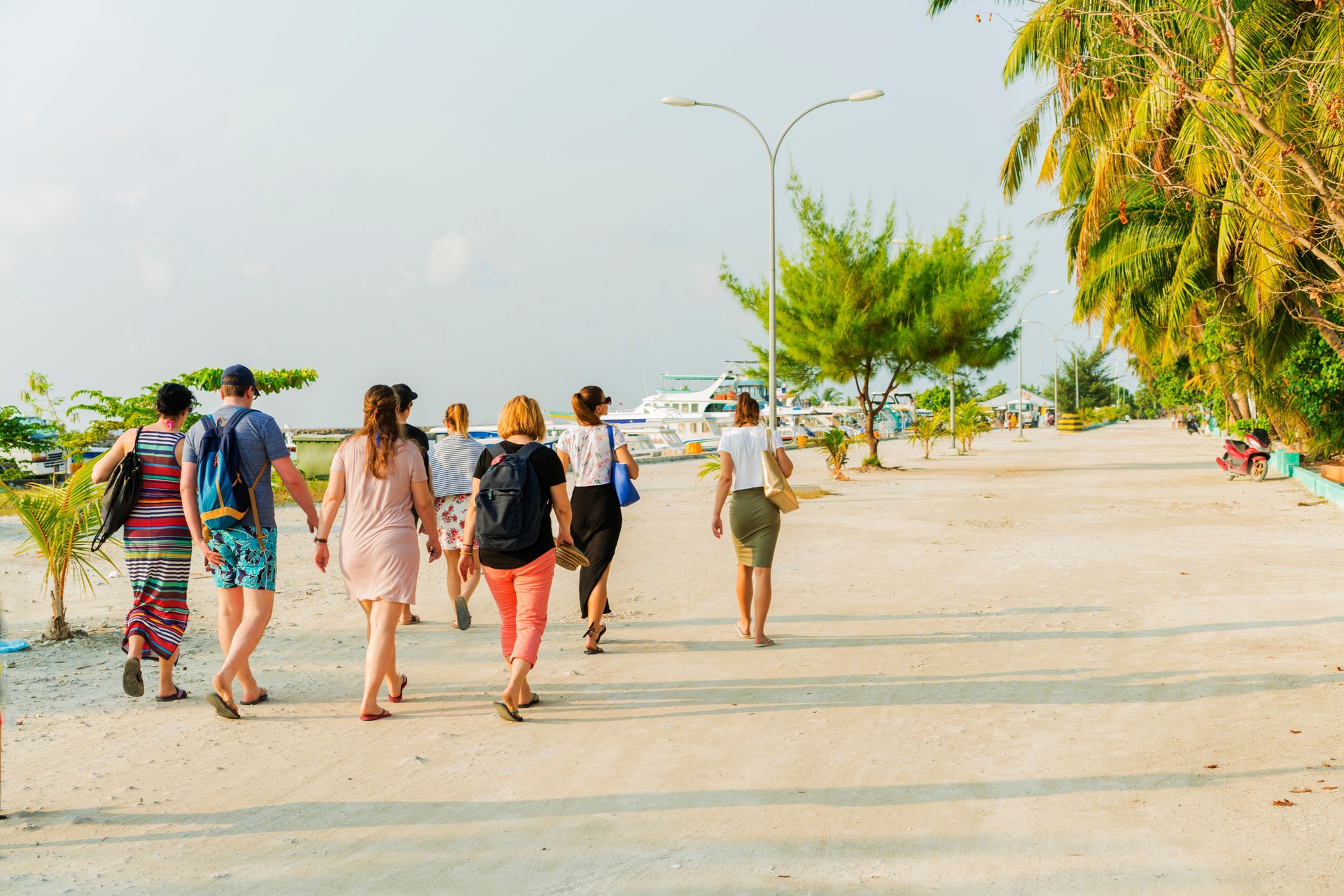 Tourists walking on Maafushi Island central street at the beginning in April, Maldives