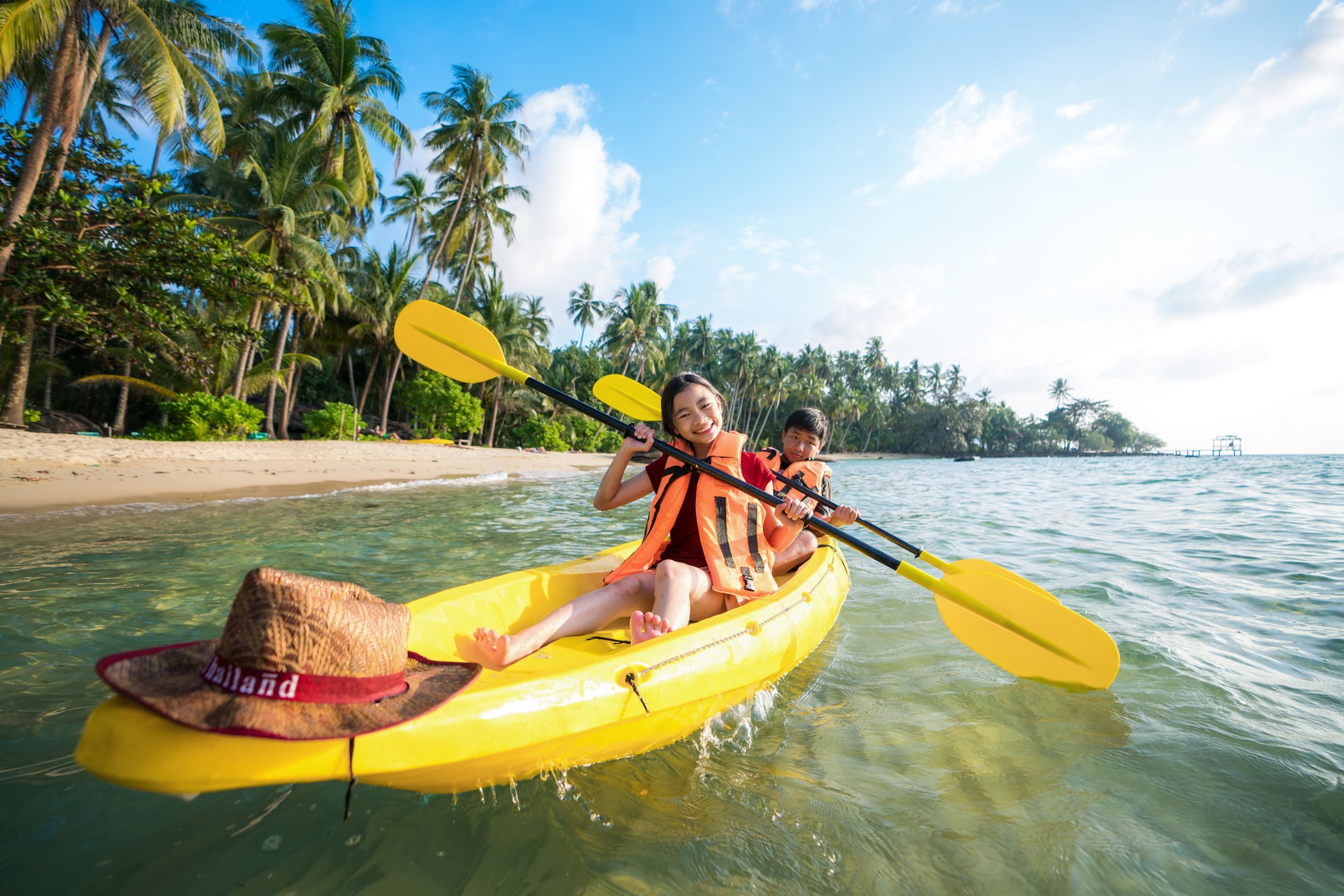 Asian kid to play Kayak on the beach on Koh Kood and Koh Mak, Koh Kood and Koh Mak is island on the sea of Thailand